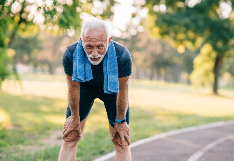 A Person struggling with shortness of breath, a symptom of heart disease in Sugar Land, TX