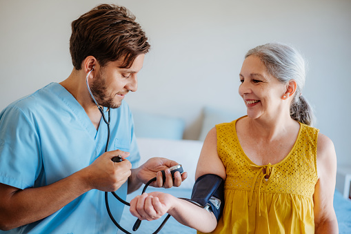 A Nurse Checks the Blood Pressure of a Senior Woman.