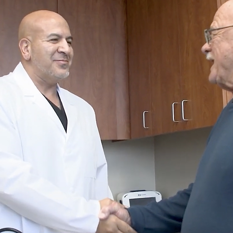 Dr. Yassir Sonbol with patient at Sugar Land TX