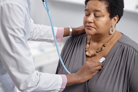 Doctor using stethoscope for heart health checkup to detect heart disease in women
