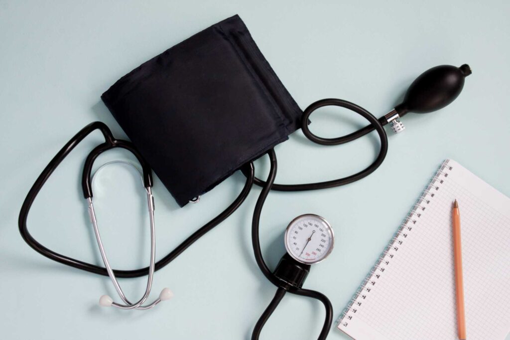 Stethoscope and blood pressure monitor, representing non-invasive cardiology care