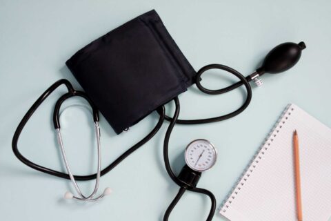 Stethoscope and blood pressure monitor, representing non-invasive cardiology care